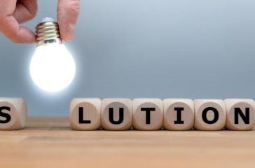 symbol-for-finding-a-solution-dice-and-a-light-bulb-form-the-word-picture-id1134956618