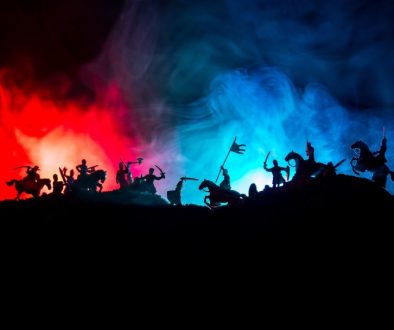 Medieval battle scene with cavalry and infantry. Silhouettes of figures as separate objects, fight between warriors on dark toned foggy background with medieval castle.