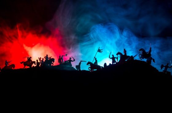 Medieval battle scene with cavalry and infantry. Silhouettes of figures as separate objects, fight between warriors on dark toned foggy background with medieval castle.