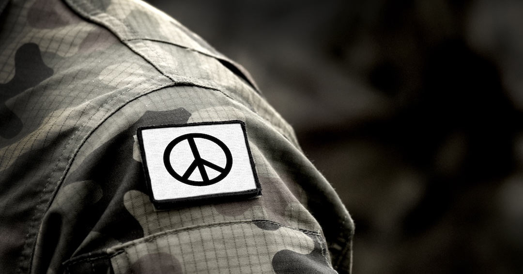 Peace sign on military uniform. The Peace symbol. Peace and war. Peace sign on military uniform. The Peace symbol. Peace and war.