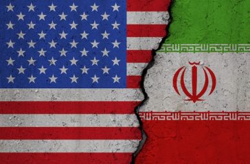 Us,And,Iran,Flags,On,Broken,Concrete