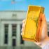 A,Gold,Bar,In,A,Man's,Hand,Against,The,Background
