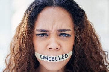Woman, portrait and tape on mouth for violence with political, protest and feminism movement for justice. Activism, victim and person with censor and cancel culture, harassment and freedom of speech