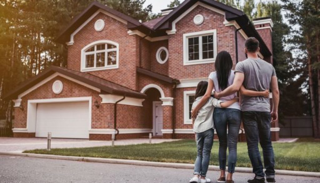 Back,View,Of,Happy,Family,Is,Standing,Near,Their,Modern