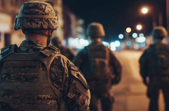 Military officer in uniform standing solemnly on deserted city street, symbolizing martial law and order in urban environment. Military officer in uniform standing solemnly on deserted city street, symbolizing martial law and order in urban environment.
