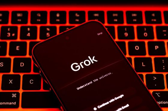 Grok AI app screen on smartphone placed on illuminated red keyboard, wide composition for artificial intelligence and online safety news coverage. Stafford, United Kingdom, January 7, 2026,