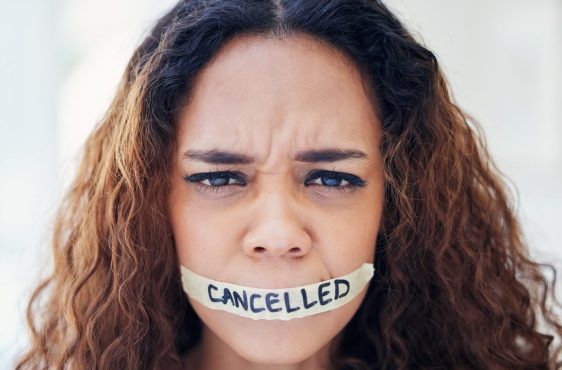 Woman, portrait and tape on mouth for violence with political, protest and feminism movement for justice. Activism, victim and person with censor and cancel culture, harassment and freedom of speech