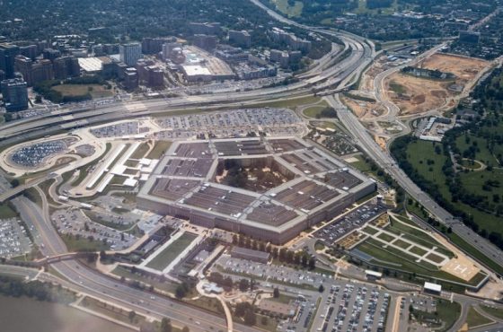 Aerial view of the Pentagon complex with surrounding roads, parking and greenery. g