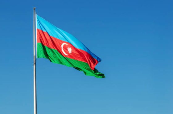 Azerbaijan flag on blue sky background.