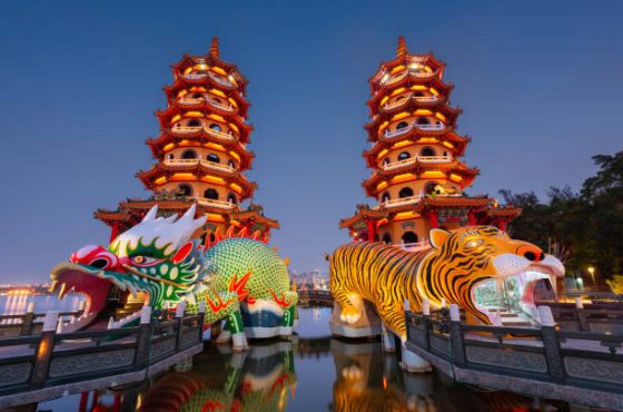 Kaohsiung, Taiwan Dragon and Tiger Pagodas at Lotus Pond at night.