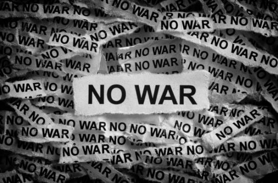 Strips of newspaper with the words No War. Black and white. Close up.