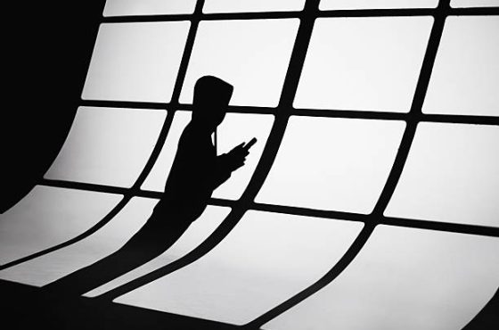 Shadow of man. Scammer. Phone fraud