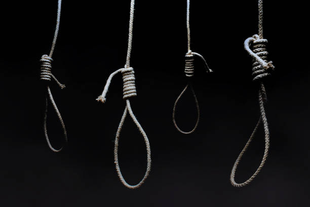 Horror photo of a dark scary hanging nooses on black background. Horror photo of a dark scary hanging nooses on black background.
